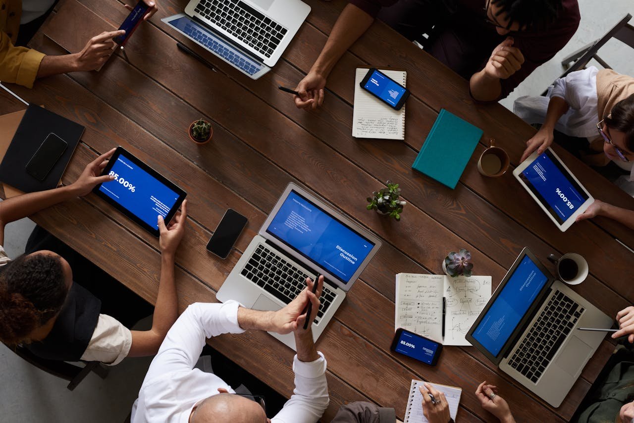 A team working together around a table with laptops and notebooks